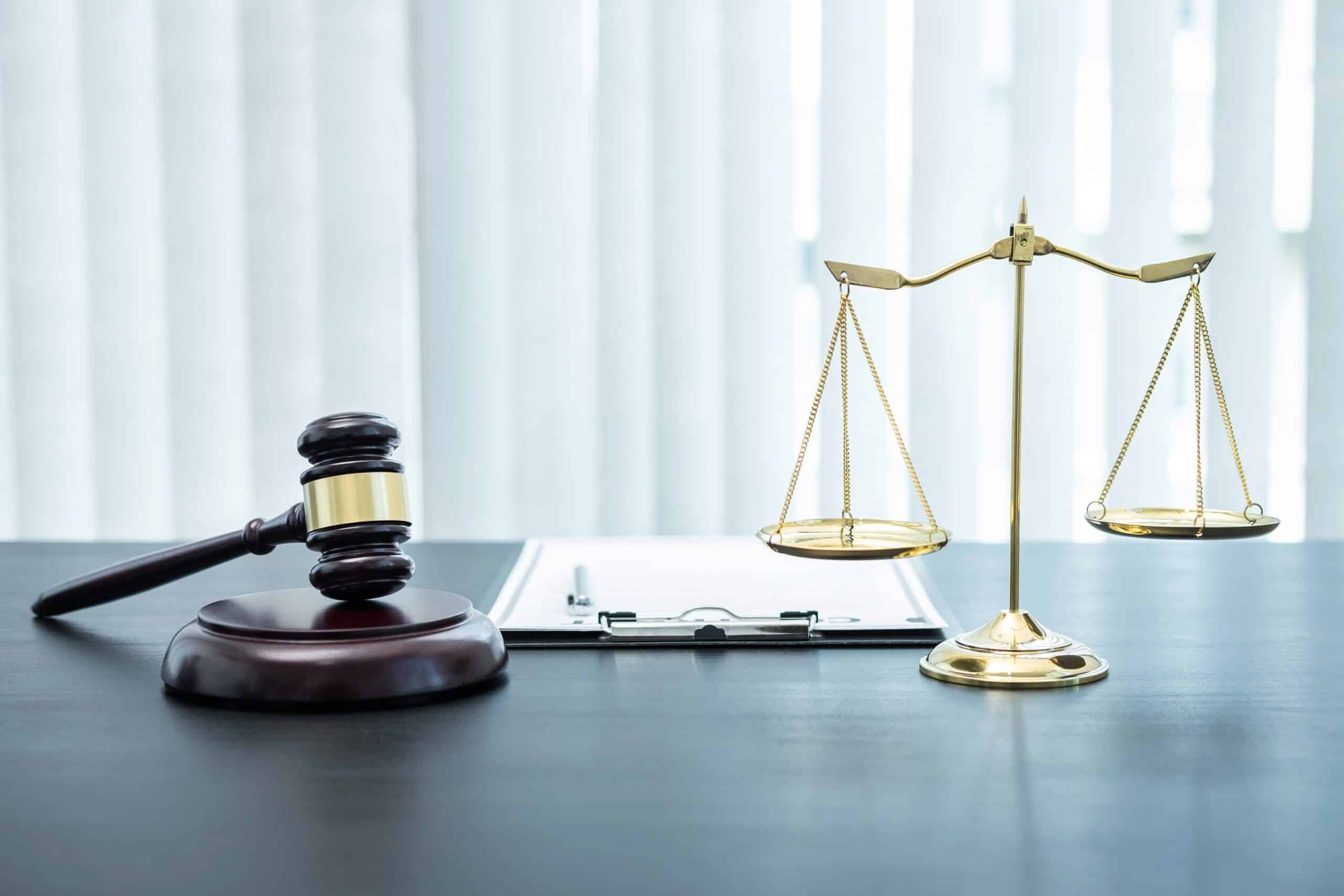 Judge gavel with Justice at law firm in background with legal ca